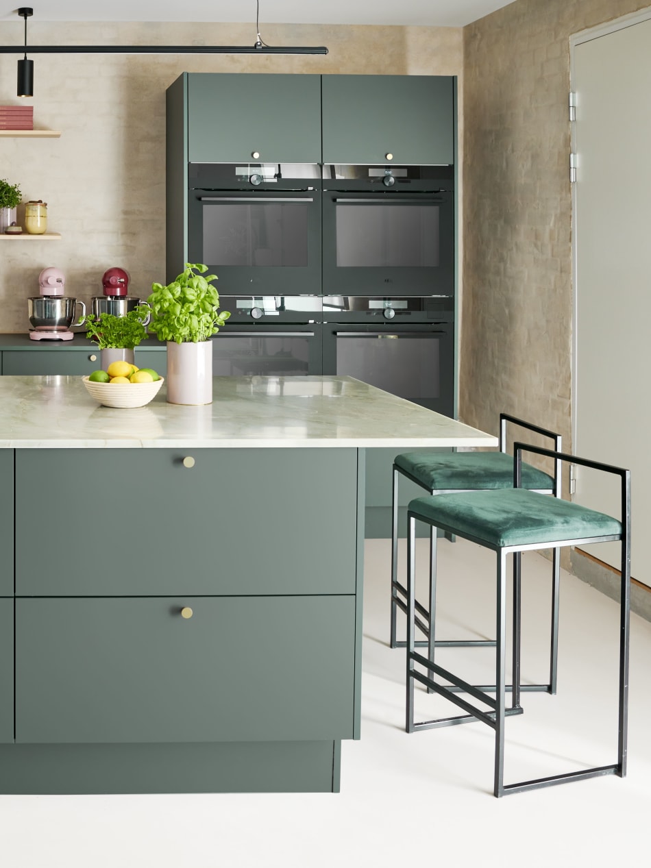 Green kitchen cabinets with matching kitchen island and barstool | HTH