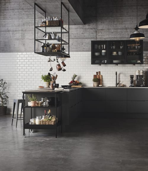 Black kitchen with white tile backsplash and dark countertop. Tendens Kitchen | HTH