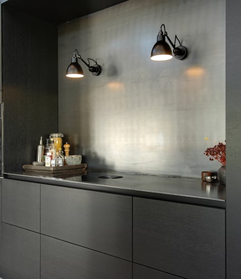 Dark kitchen cabinets with integrated appliances and backsplash | HTH