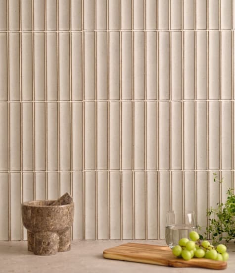 Beige vertical tile backsplash with light countertop. Reflection | HTH
