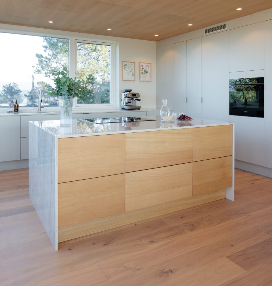 Wood kitchen island with white cabinets and wood floor | HTH
