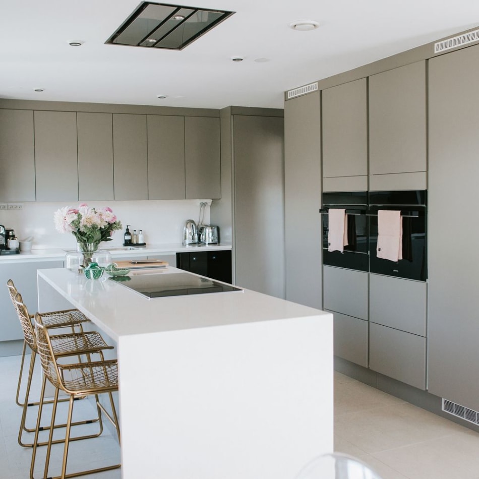 Gray kitchen cabinets and white kitchen island with integrated appliances | HTH