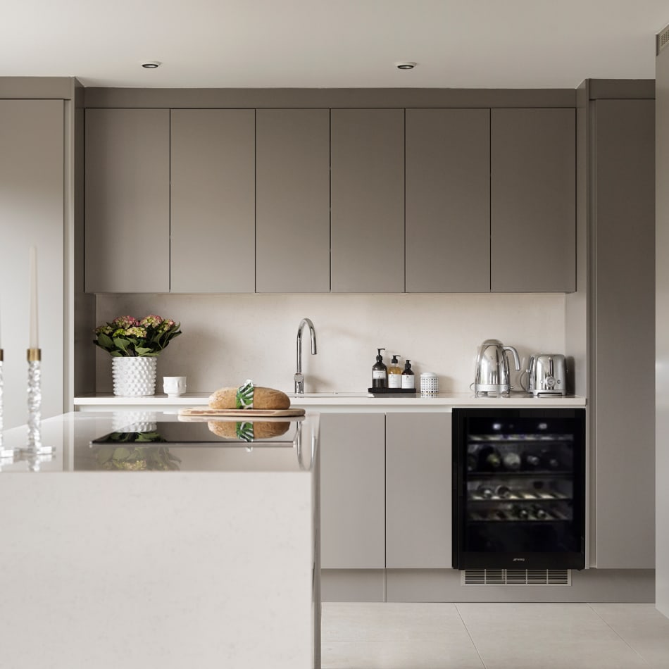 Gray kitchen cabinets with a white countertop and a black wine cooler | HTH