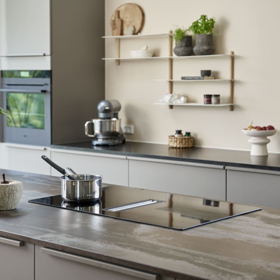 Modern kitchen featuring gray cabinetry, dark countertops, and built-in appliances. Sleek minimalist design | HTH