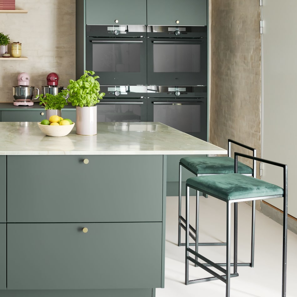 Green kitchen cabinets with matching kitchen island and barstool | HTH