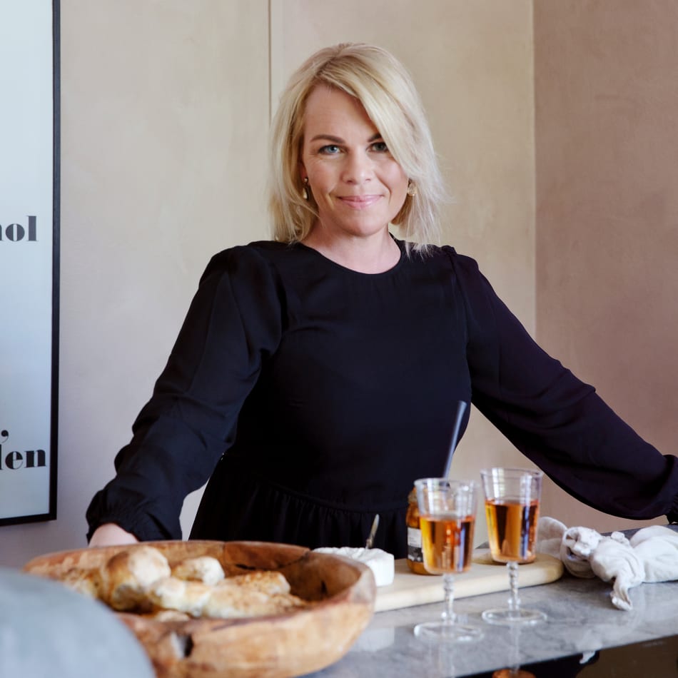 Person in black shirt at kitchen countertop with drinks and bread | HTH
