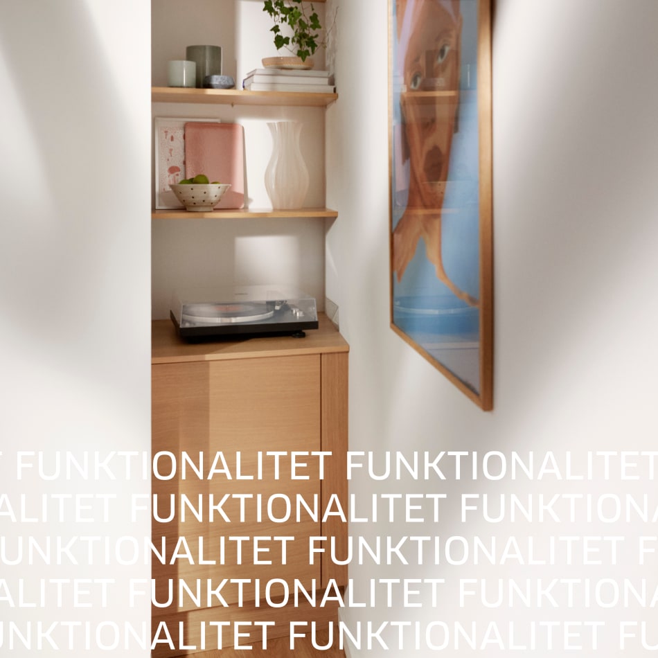 Wooden kitchen shelves with beige cabinets and wall art | HTH