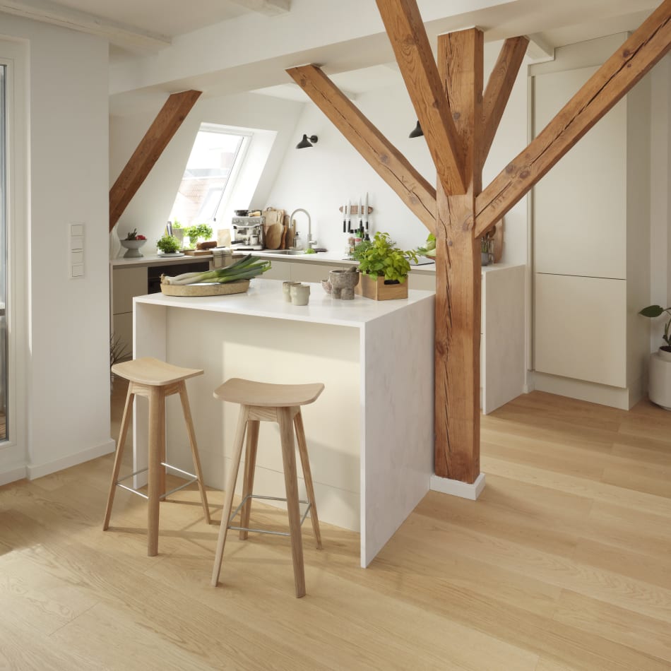 White kitchen with wooden beams and stools, light wood flooring, white cabinets | HTH