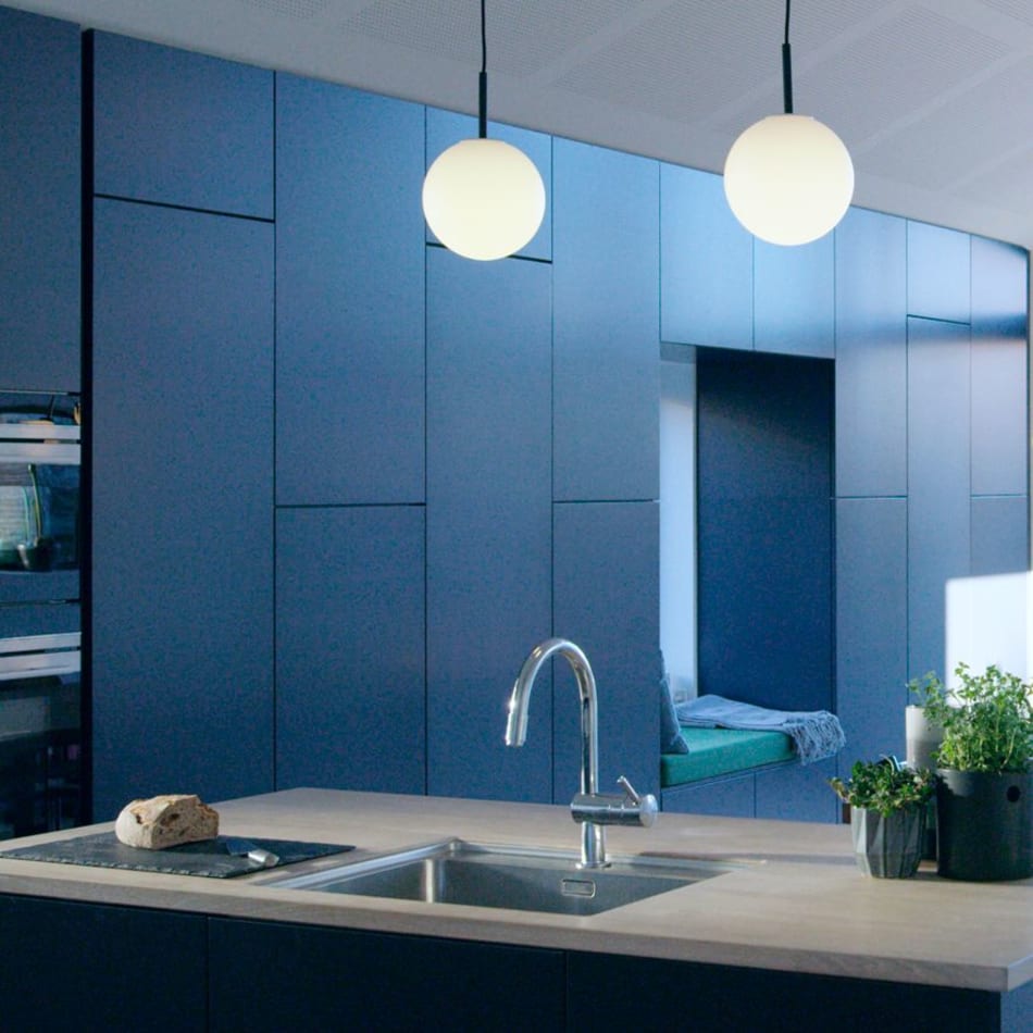 Blue kitchen cabinets with a light countertop and kitchen island | HTH