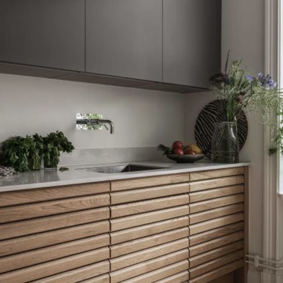 Wooden kitchen cabinets with gray upper cabinets and white countertop | HTH