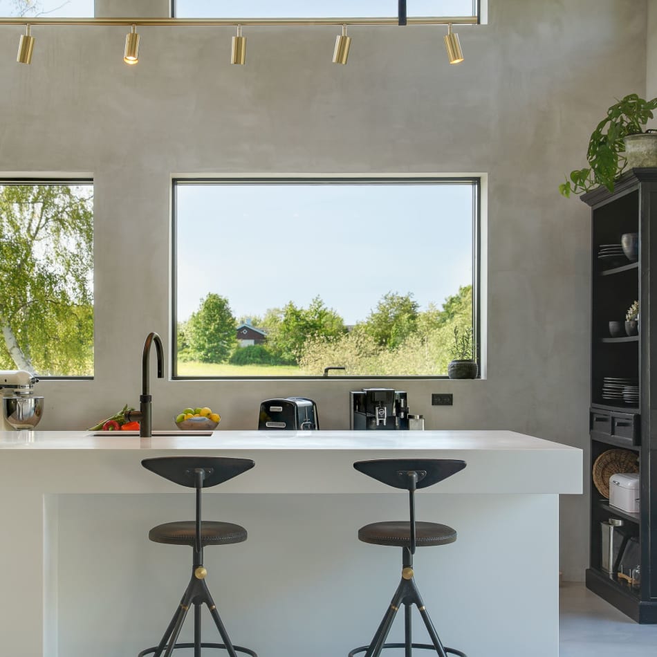 White kitchen island with two stools and black shelving unit | HTH