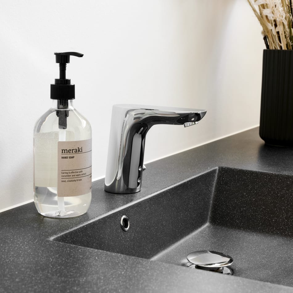 Black bathroom countertop with integrated sink and chrome faucet | HTH