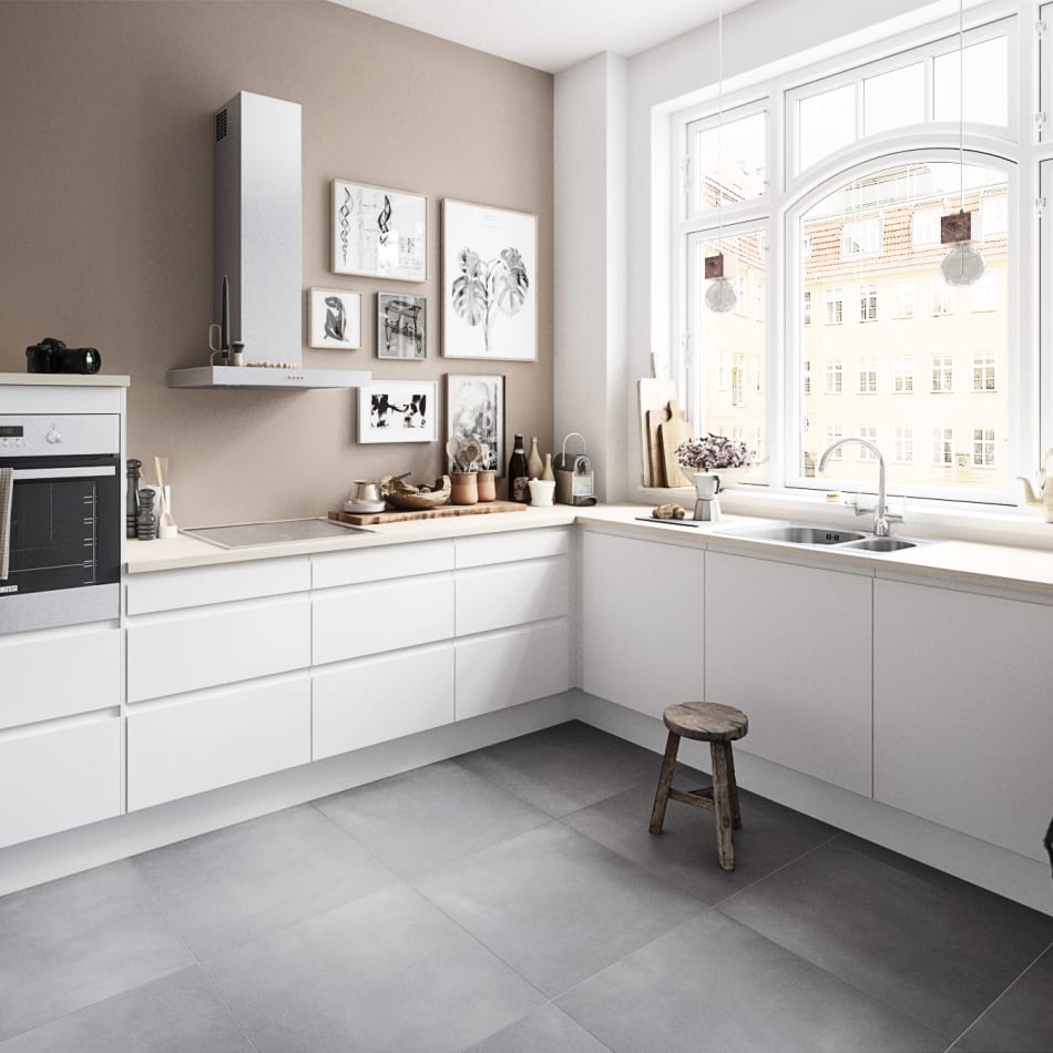 White handleless kitchen with beige walls and gray tile floor. Next | HTH