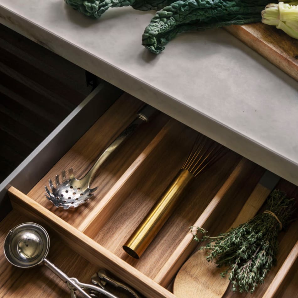 Wooden kitchen drawer with utensils under a light gray countertop. Nordic Atmosphere | HTH