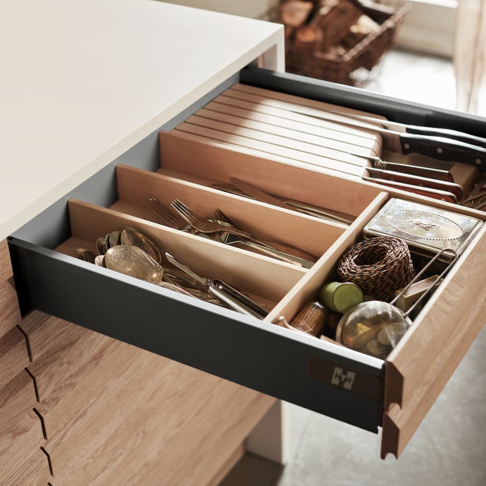 Wooden kitchen drawer with dividers, white countertop above. Nordic Spirit | HTH
