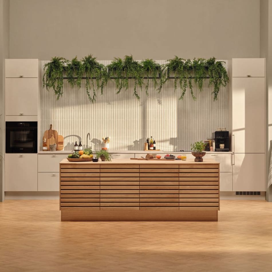 White kitchen with wood kitchen island and integrated appliances. Reflection | HTH
