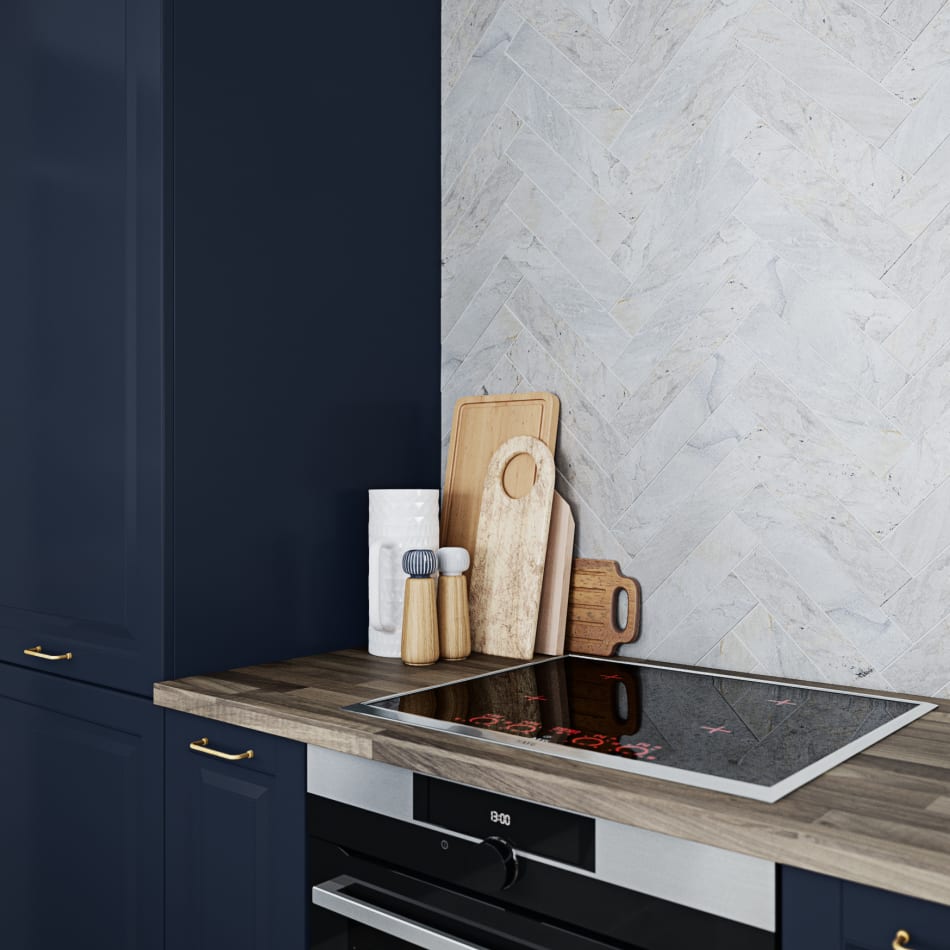 Navy blue kitchen cabinets with wood countertop and stainless steel stove. Scandinavian Classic | HTH