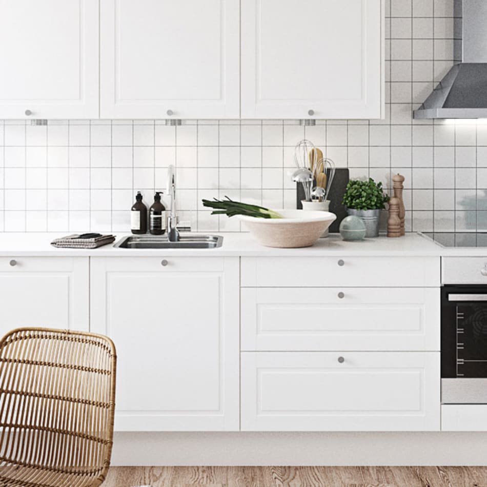 White kitchen cabinets with silver handles and a tiled backsplash. Sense Kitchen | HTH