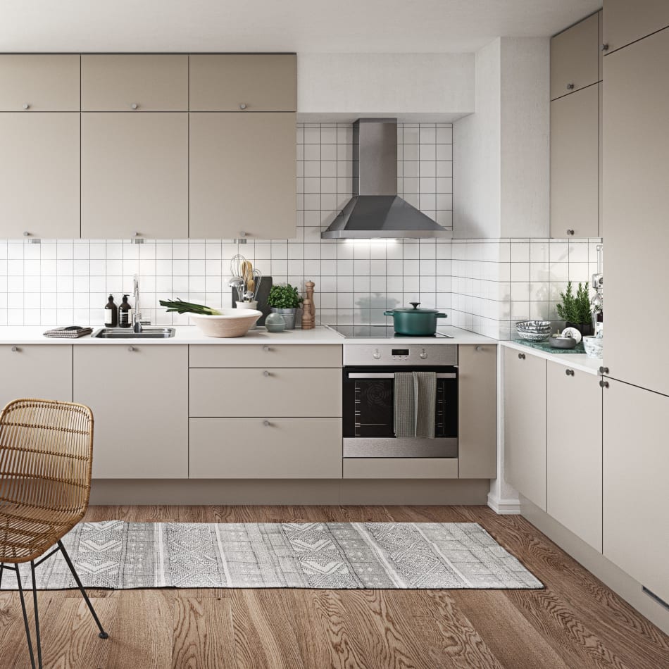 Beige kitchen cabinets with white tiled backsplash and stainless steel oven. Stockholm Kitchen | HTH