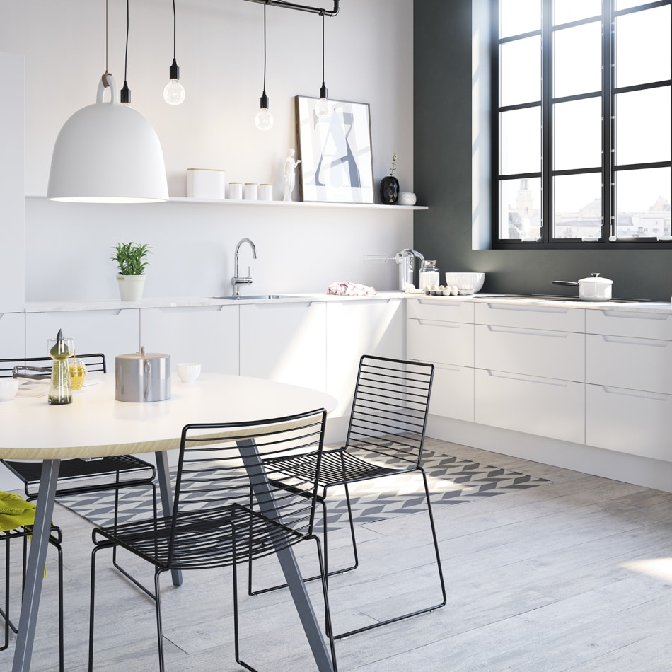 White kitchen with black handles, white countertop, and black oven. Tendens Kitchen | HTH
