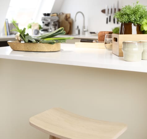 Wooden stool and white countertop in kitchen | HTH