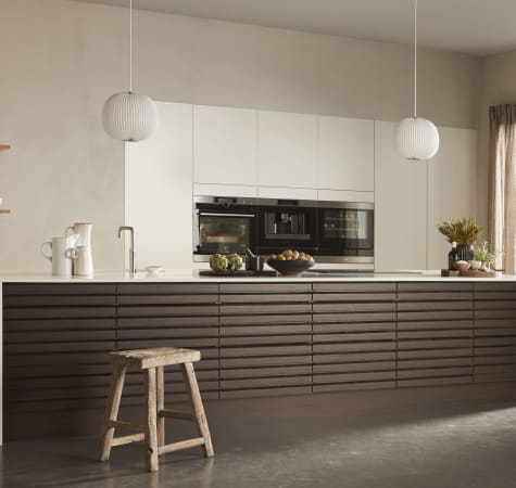 Dark wood kitchen with white countertop and cabinets, featuring built-in appliances. Harmony Dark | HTH