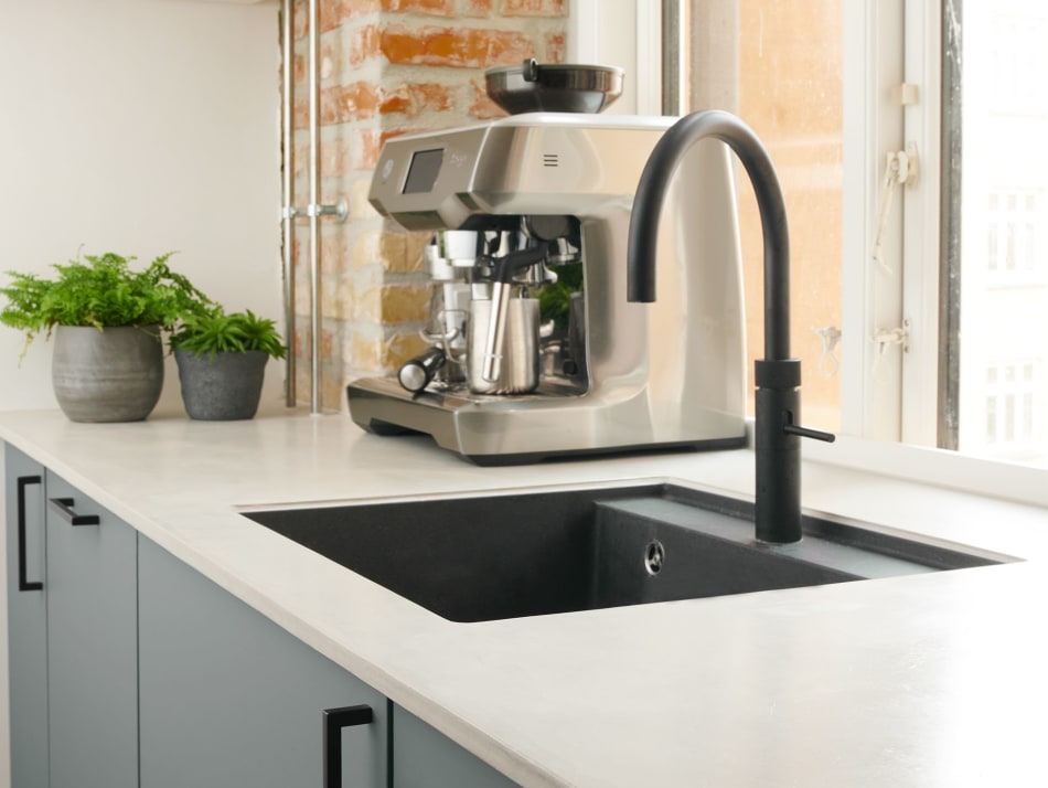 Gray kitchen cabinets with black handles and a black sink | HTH