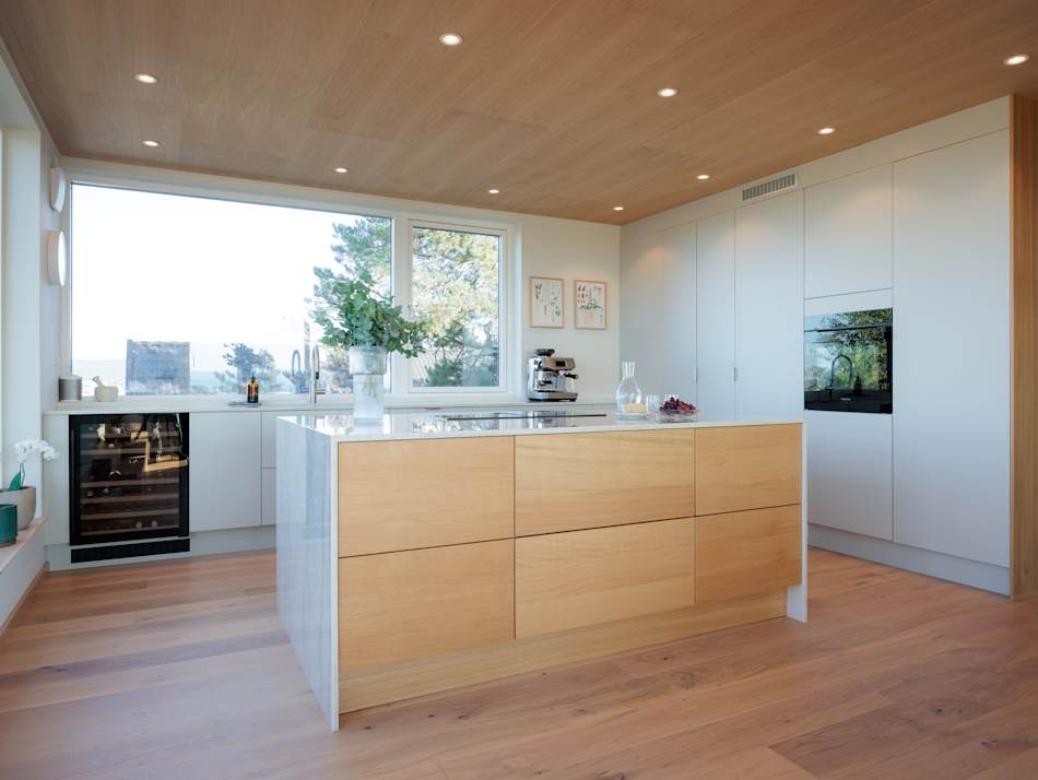 Wooden kitchen island with white cabinets and wood floor | HTH