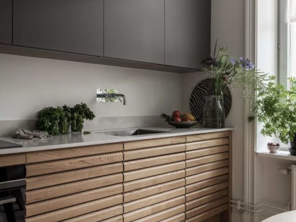 Wooden kitchen cabinets with gray upper cabinets and white countertop | HTH