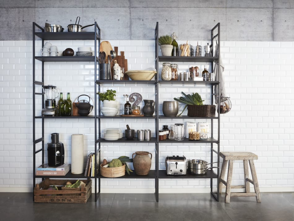 Black metal shelving with kitchen items against white tile wall | HTH