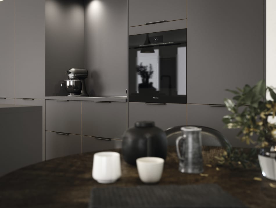 Gray kitchen cabinets with integrated oven and dark wood countertop. Focus | HTH