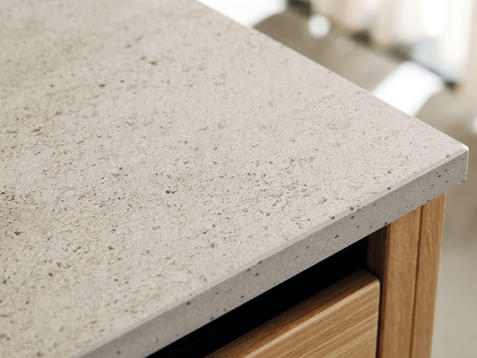 Light gray speckled countertop with wooden cabinet edge. Nordic Creation | HTH