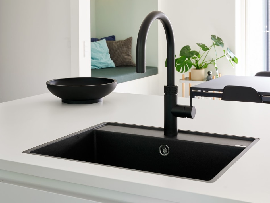 Black kitchen island sink with black faucet and white countertop | HTH