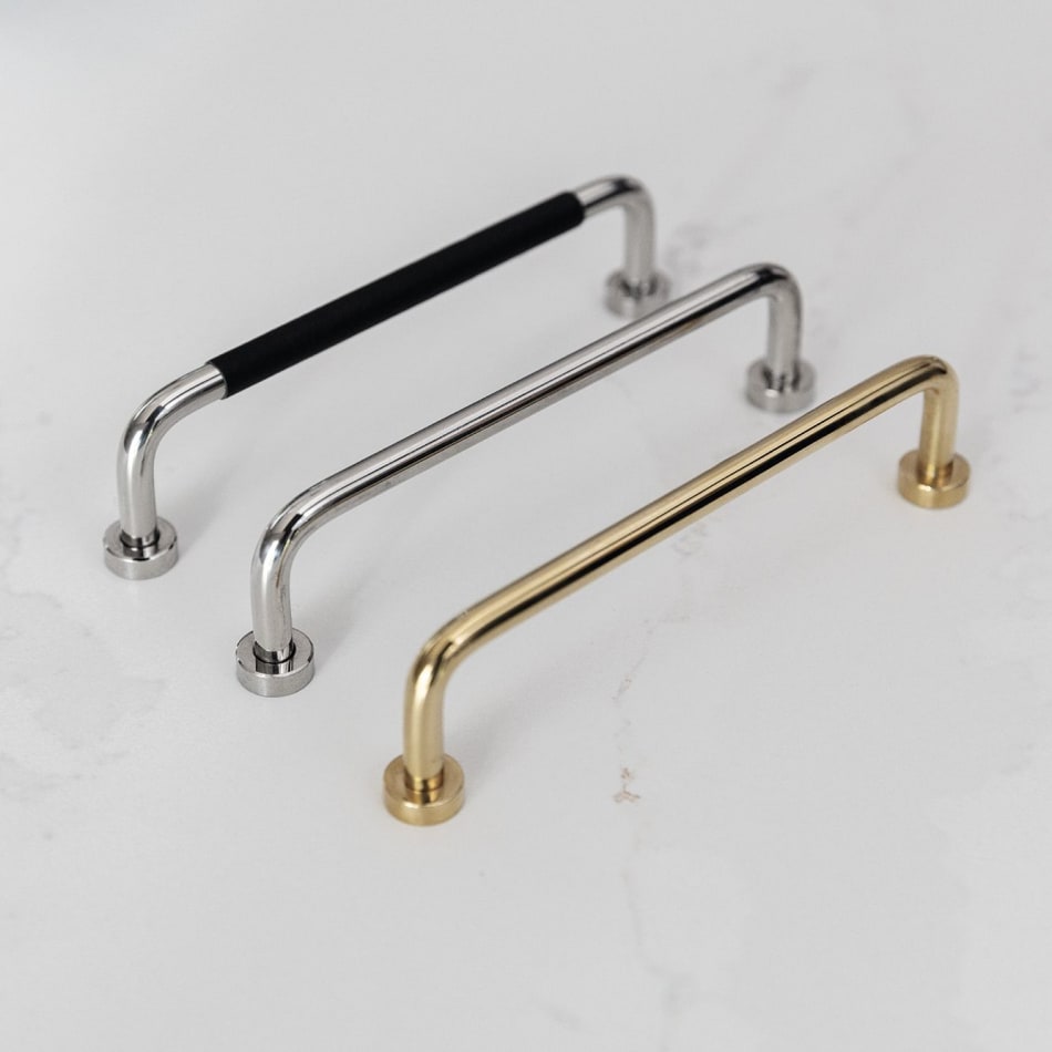 Three metal kitchen handles in silver, black, and gold on white surface | HTH