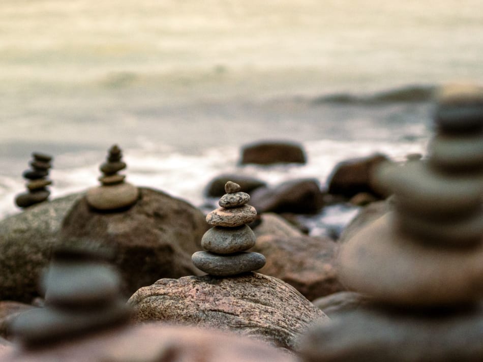 a group of rocks stacked on top of each other on a beach