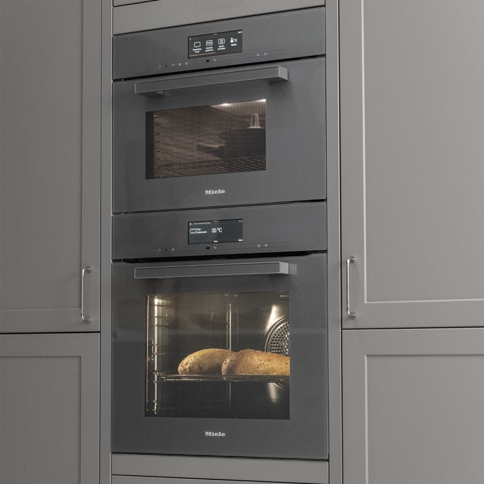 Gray kitchen cabinets with built-in Miele ovens. Model Art | HTH