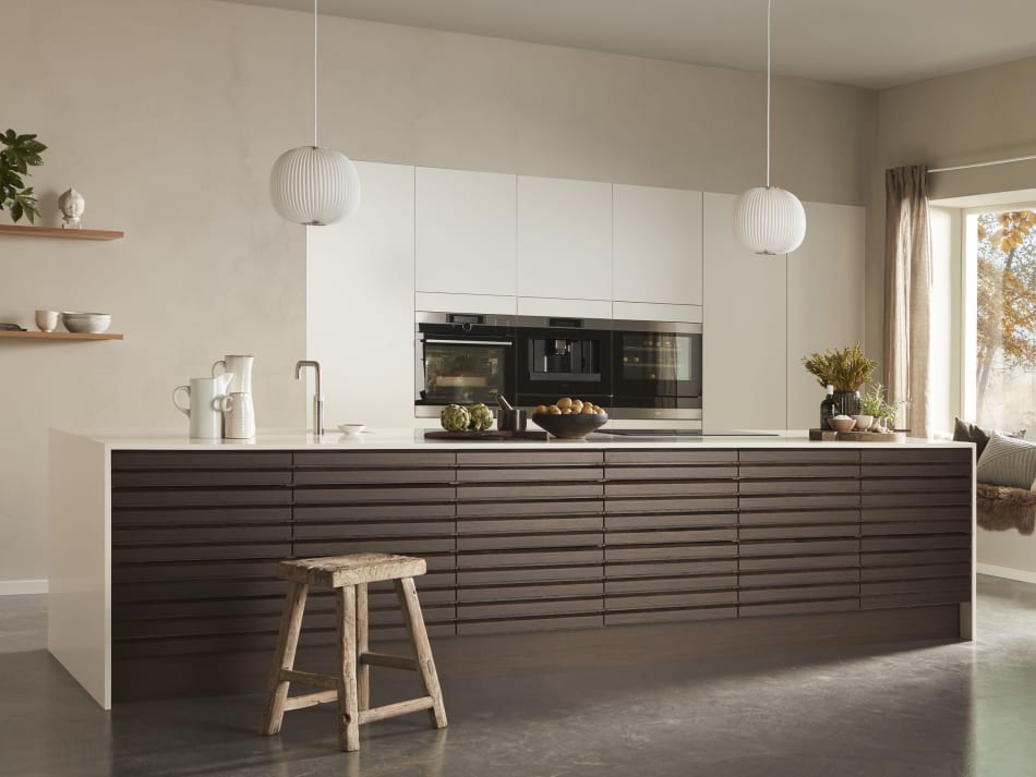 Dark wood kitchen with white countertop and cabinets, featuring built-in appliances. Harmony Dark | HTH