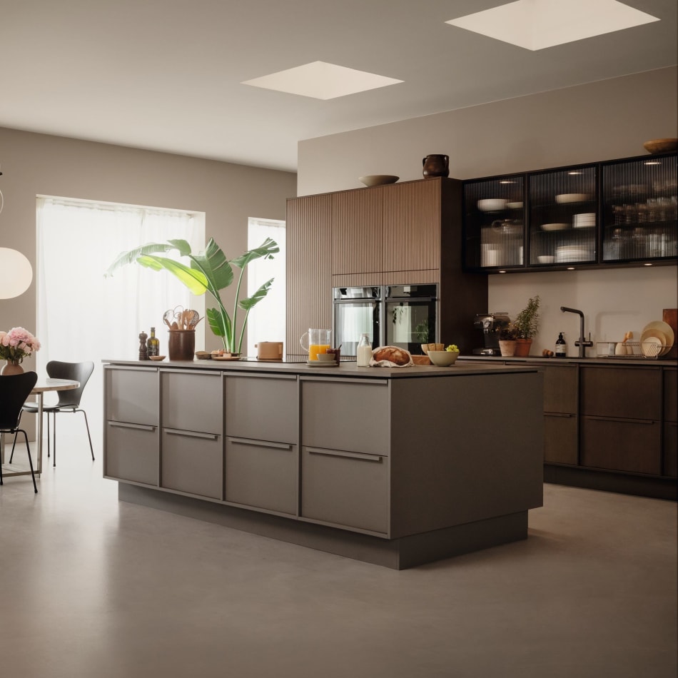 Brown kitchen with kitchen island, dark countertop, and black cabinets. Nordic Atmosphere | HTH